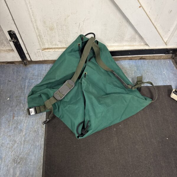 Green canvas gardening bag with shoulder straps for garden tools.
