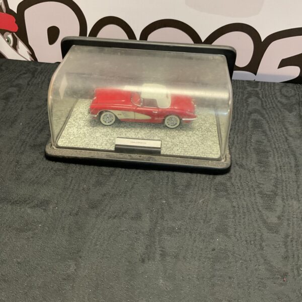 Cased Franklin Mint 1959 Corvette diecast model car on display.