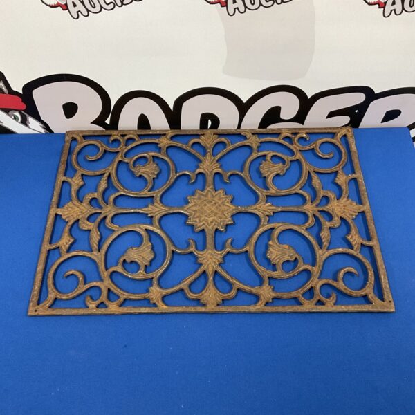 Ornate Art Nouveau cast iron doormat with floral design.