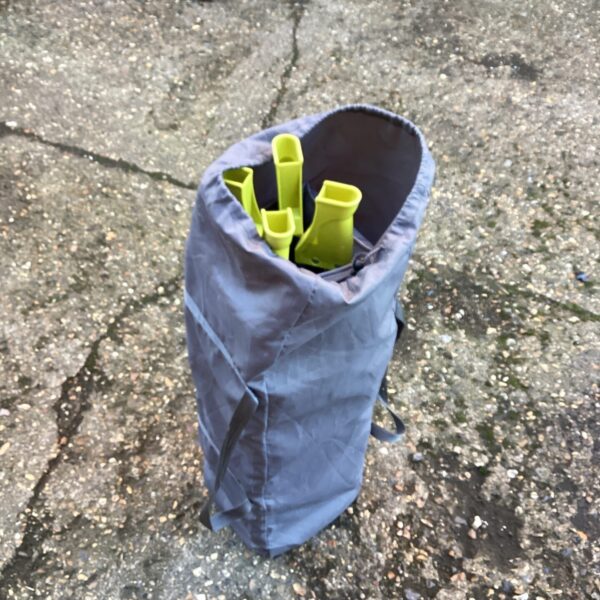 Folded childs travel cot with carry bag.