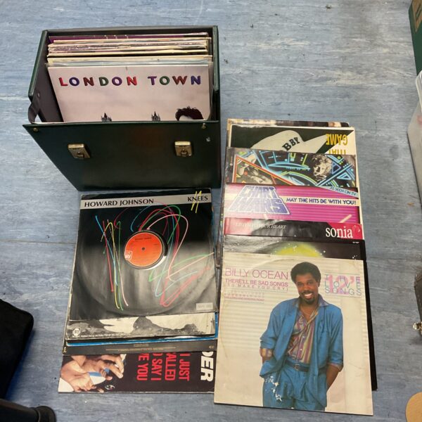 Vintage vinyl record collection in a hard-shell carrying case.