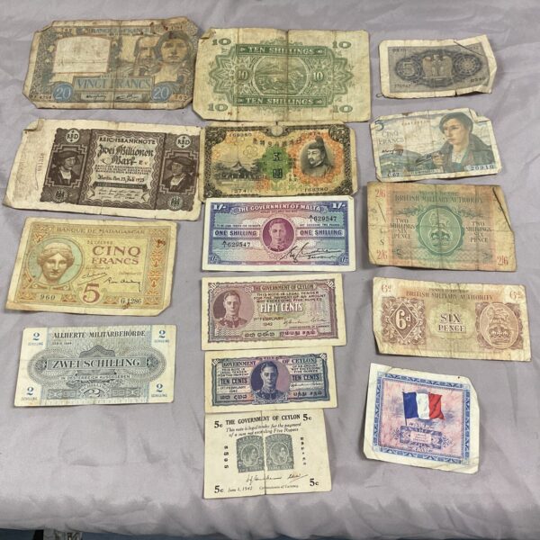 Collection of vintage wartime bank notes from various countries.