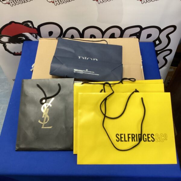 Luxury designer shopping bags from Selfridges and YSL, a collectible lot.