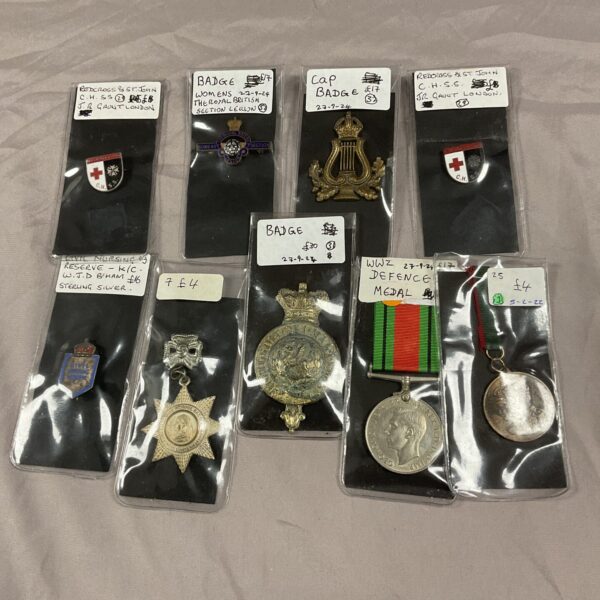 Vintage collection of enamel badges and medals, British military collectibles.