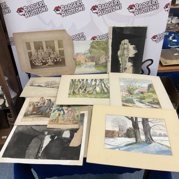 Vintage artwork collection in a folder, antique prints and paintings.