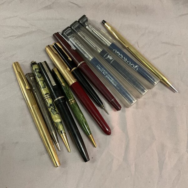 Vintage pen collection including Parker pens and writing instruments.