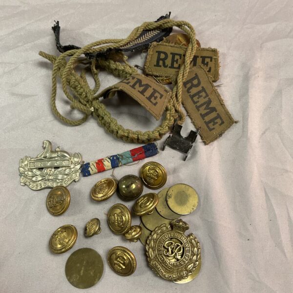 WWII British military badges and buttons collection, vintage insignia.