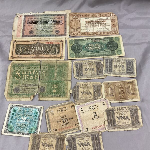 WWII banknote collection featuring German and Italian currency.
