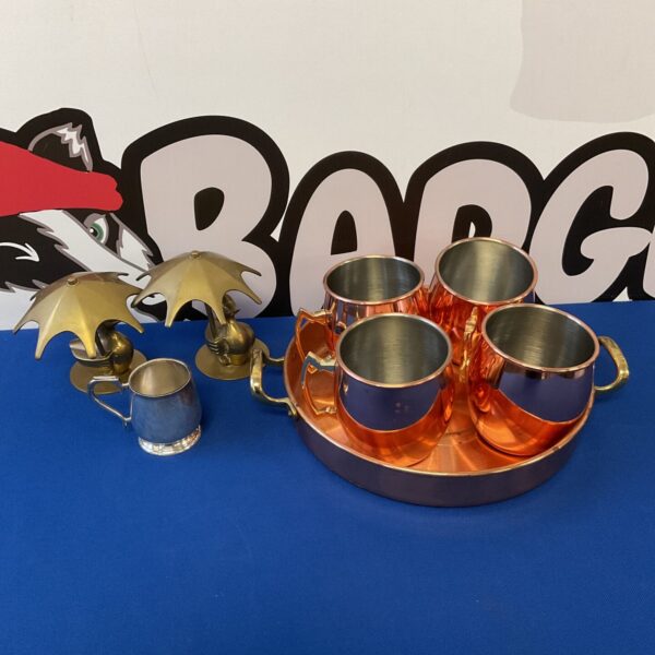 Vintage copper tray with Moscow Mule mugs and brass ducks.