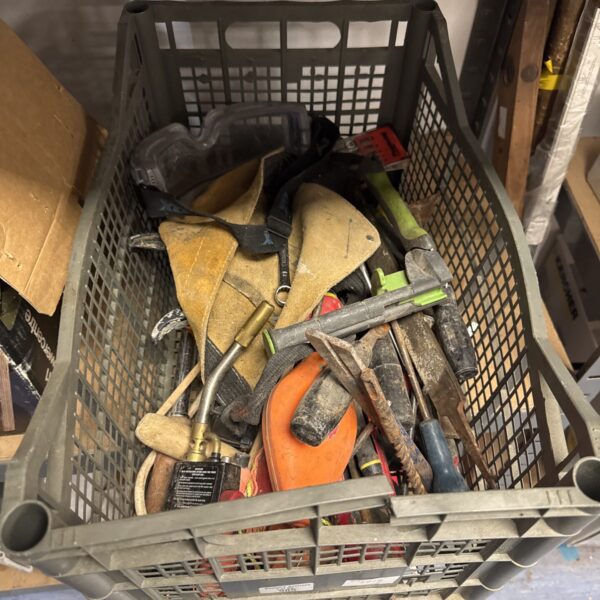 Crate filled with a mixed lot of vintage hand tools.
