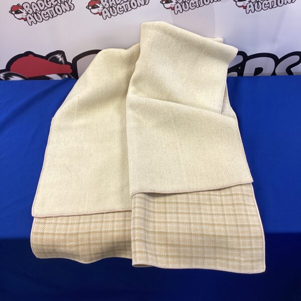 Cream textured blanket for home decor and comfort.