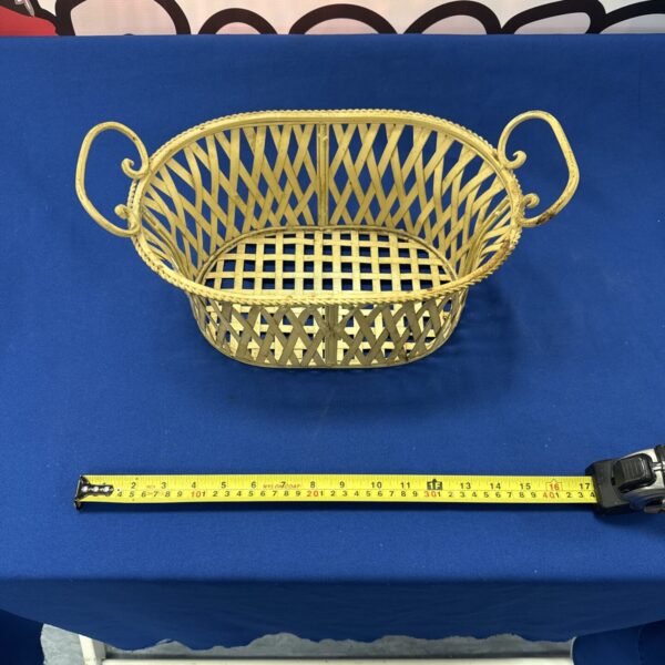 Golden decorative metal basket with openwork design.