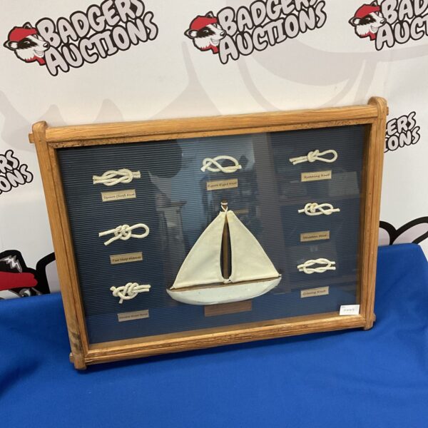 Framed nautical knot display with driftwood frame, showcasing sailing knots.