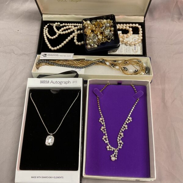Vintage costume jewellery lot featuring necklaces and earrings.