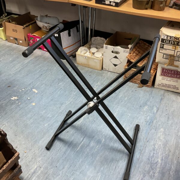 Black folding keyboard stand for musicians and home use.