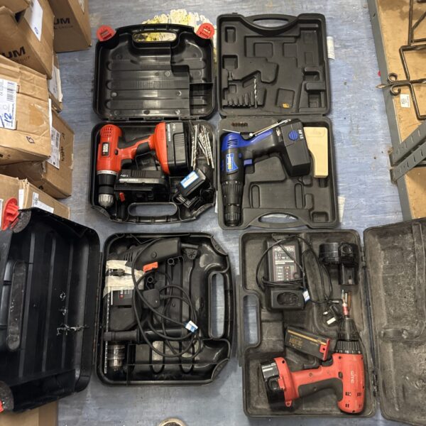 Assorted power tools in carrying cases, untested DIY collection.