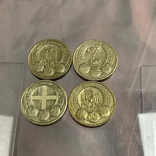 Four UK £1 coins featuring London and Edinburgh designs.