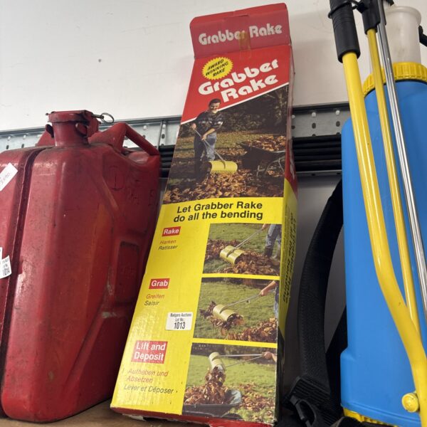 Metal garden grabber rake for collecting leaves and garden debris.