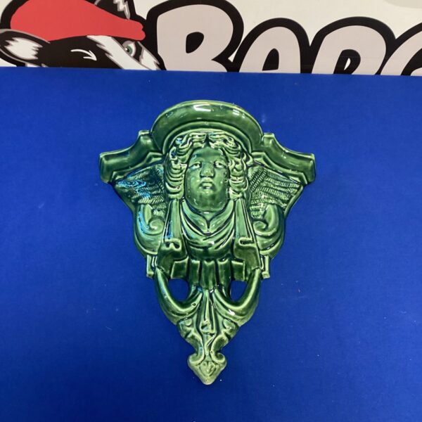 Vintage ceramic wall hanging vase with floral design.