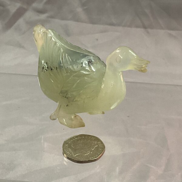 Green jade duck figure, detailed carving, collectible sculpture.