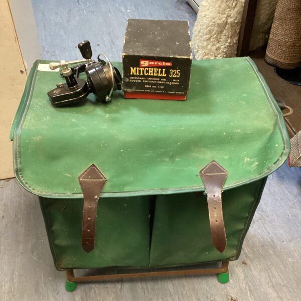 Vintage Garcia Mitchell 325 fishing reel with green seat.
