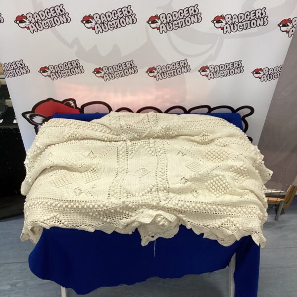 Vintage hand crocheted bedspread with intricate detailing.