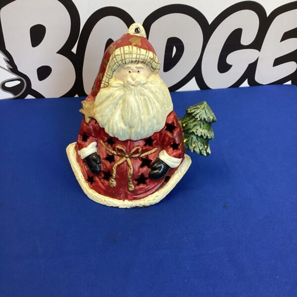 Vintage cast iron Santa candle holder for Christmas decor.