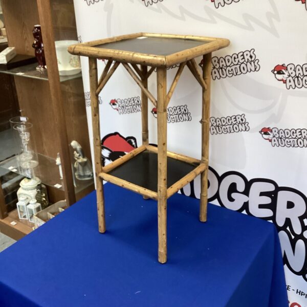 Vintage bamboo plant stand with tripod base for home decor.