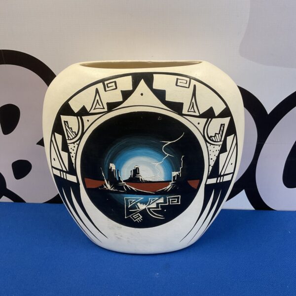 Hand-painted Navajo pottery vase with intricate geometric designs.