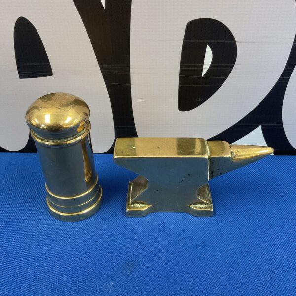 Vintage brass jewellers anvil and letterbox on display.