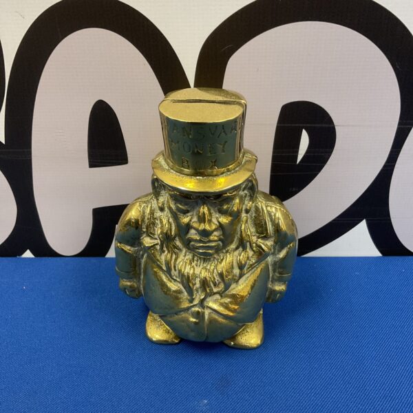 Vintage brass Transvaal moneybox featuring a detailed African figure.