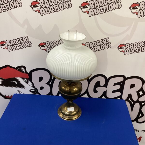Vintage brass oil lamp with clear glass shade.