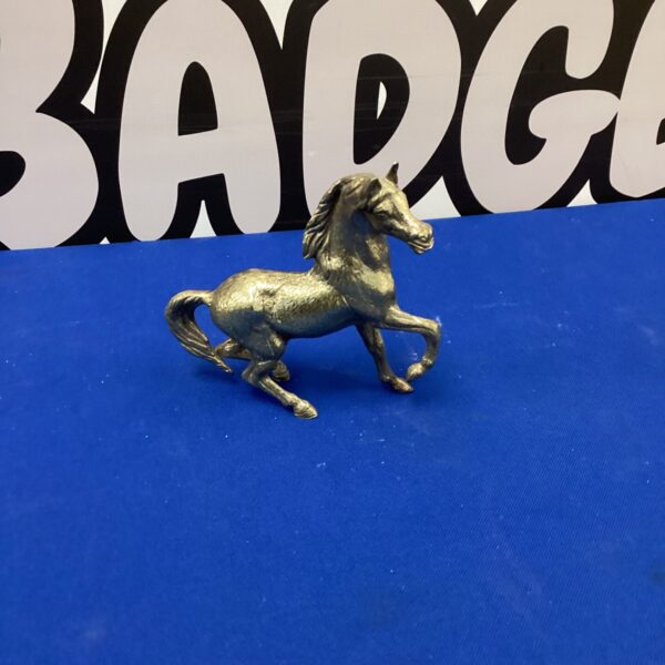 Vintage brass horse figurine, detailed equestrian sculpture.