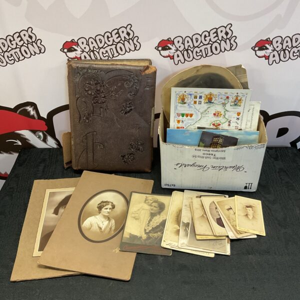 Antique photograph collection with vintage ephemera and portraits.