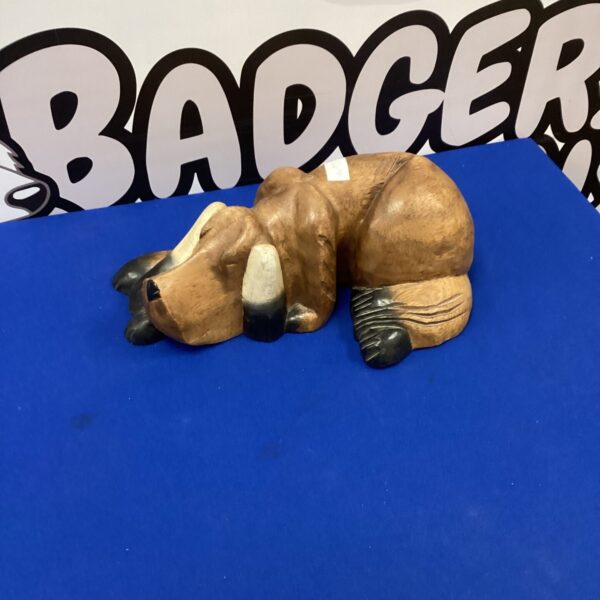 Vintage wooden sleeping dog door stop for home decor.