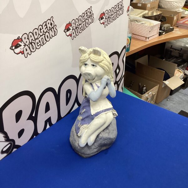 Whimsical Miss Piggy garden ornament for outdoor decor.