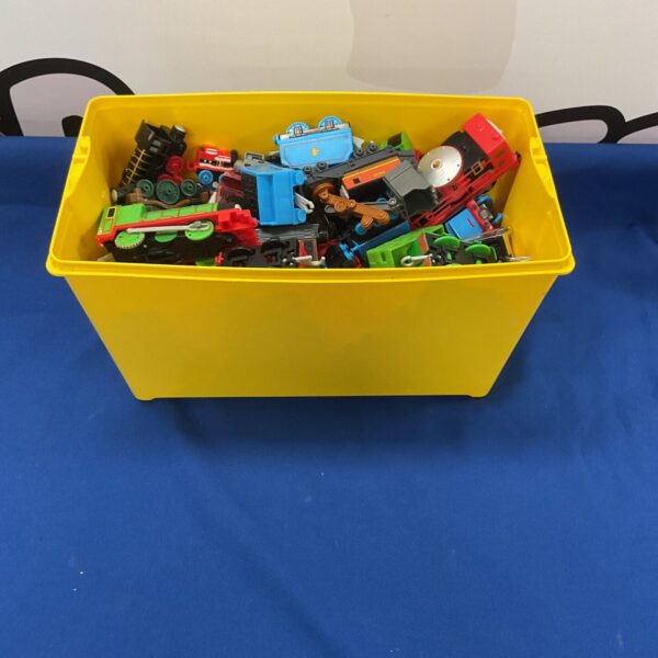 A box of Thomas the Tank Engine toys and railway accessories.