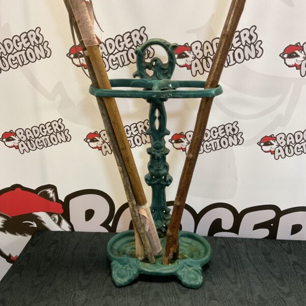 Ornate Victorian cast iron stick stand for hall decor.