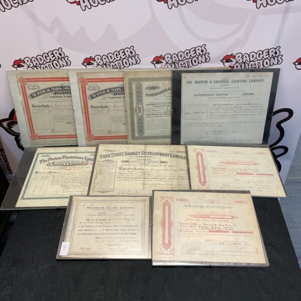 Framed lot of vintage bond certificates, collectible financial documents.