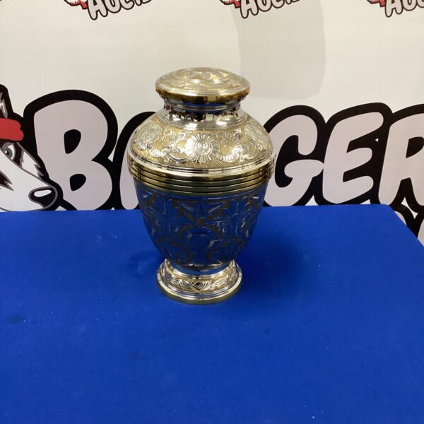 Silver ornate cremation urn, decorative keepsake for remains.