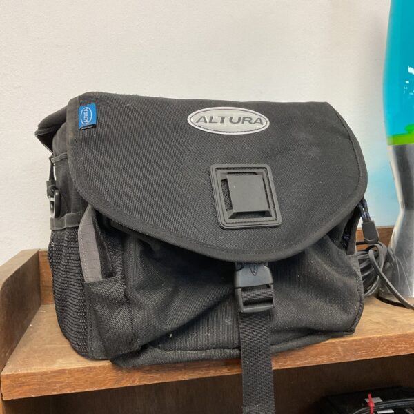 Black Altura camera bag with adjustable shoulder strap.