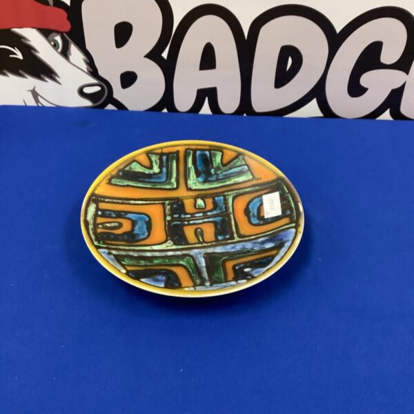 Vibrant Poole Pottery plate with abstract design and textured glaze.