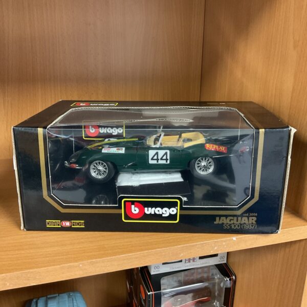 Detailed Burago 1/18 scale Jaguar SS100 model car on display.