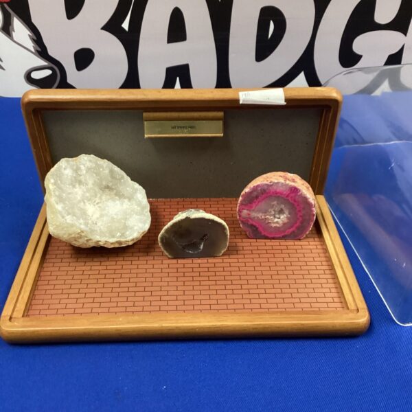 Vintage display case with polished agate and crystal stones.