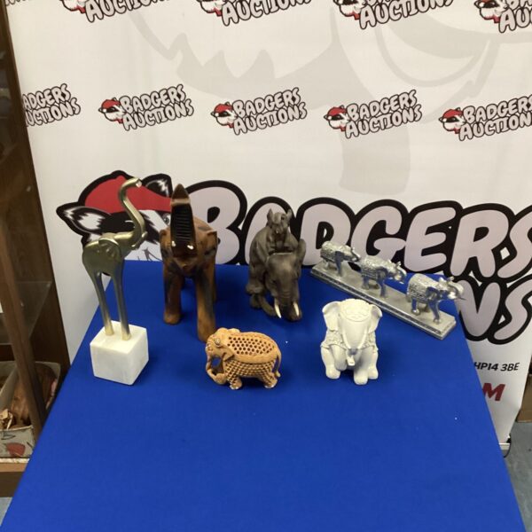 Vintage carved wooden elephant figurines for collectors and home decor.