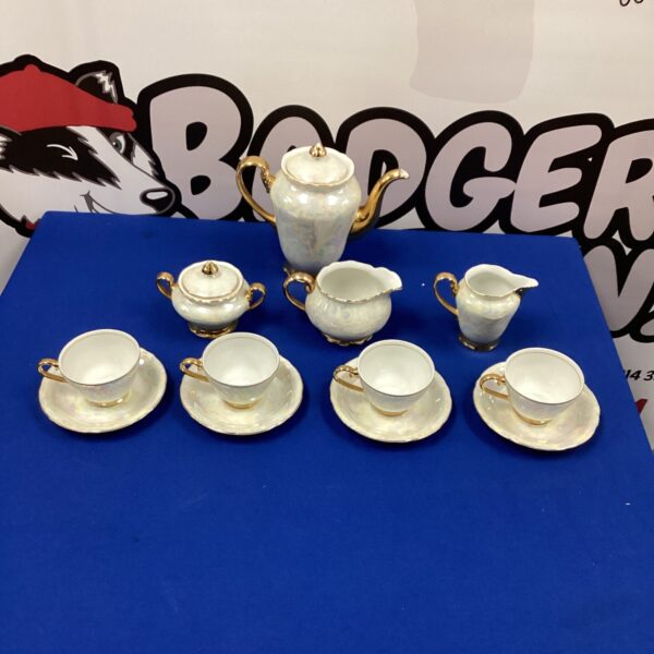Vintage Czechoslovakian porcelain coffee set with gold accents.