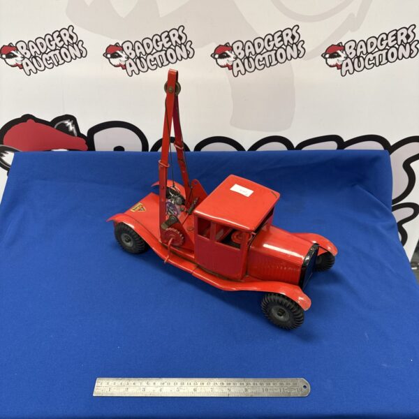 Vintage Tri-ang recovery truck, side view, red tinplate toy.