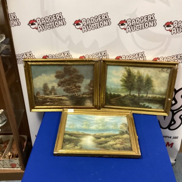 Three framed oil paintings depicting peaceful country scenes.