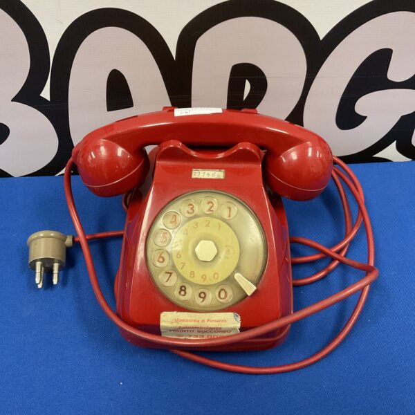 Red vintage Siemens rotary telephone, classic mid-century design.