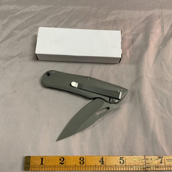 Close-up of a new D2 steel pocket knife with stainless steel handle.